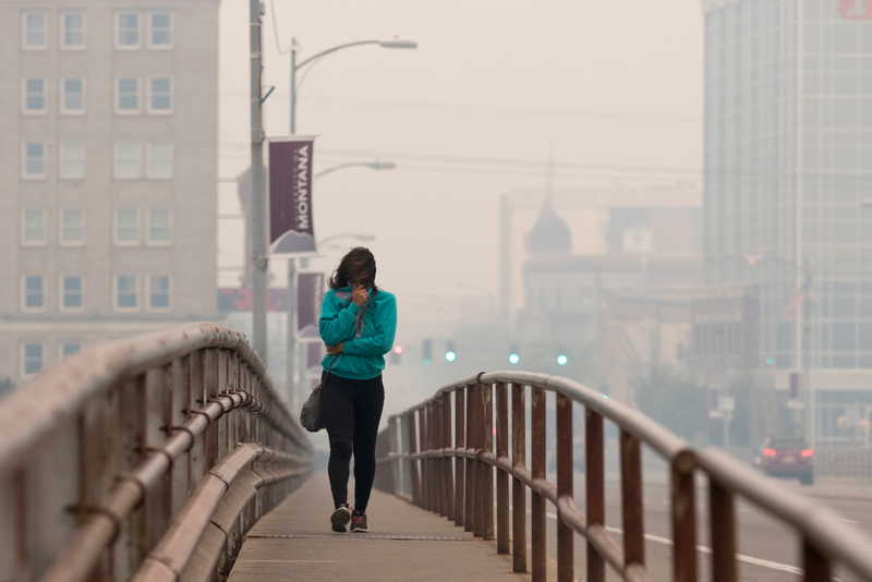 Tatiana Weed walks to work in Missoula, Mont. as smoke from the nearby Lolo Peak Fire fills the air on Monday, Sept. 4, 2017. “I can’t breathe. I woke up this morning and all I could smell was a campfire,” Weed said. The air quality is has been measured at hazardous by the Montana Department of Environmental Quality. (AP Photo/Patrick Record)